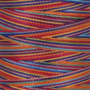 Close up of tangled multicolored yarn strands in vibrant reds blues yellows and greens