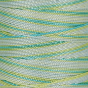 Close up of pastel colored braided ropes overlapping in blue green and yellow tones