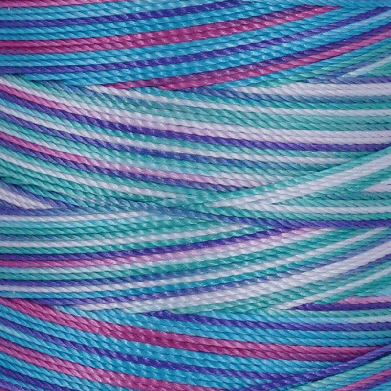 Close up of pastel colored twisted yarn threads in blue pink purple and green