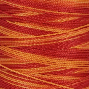 Close up of intertwined orange and red yarn strands