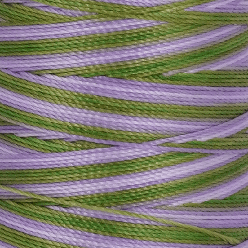 Close up of intertwined purple and lime green braided cords creating a textured pattern