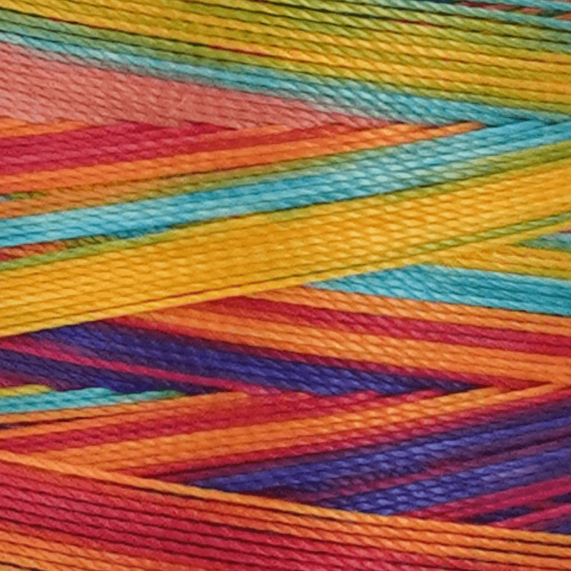 Close up of vibrant multicolored yarn skeins twisted together in rainbow hues